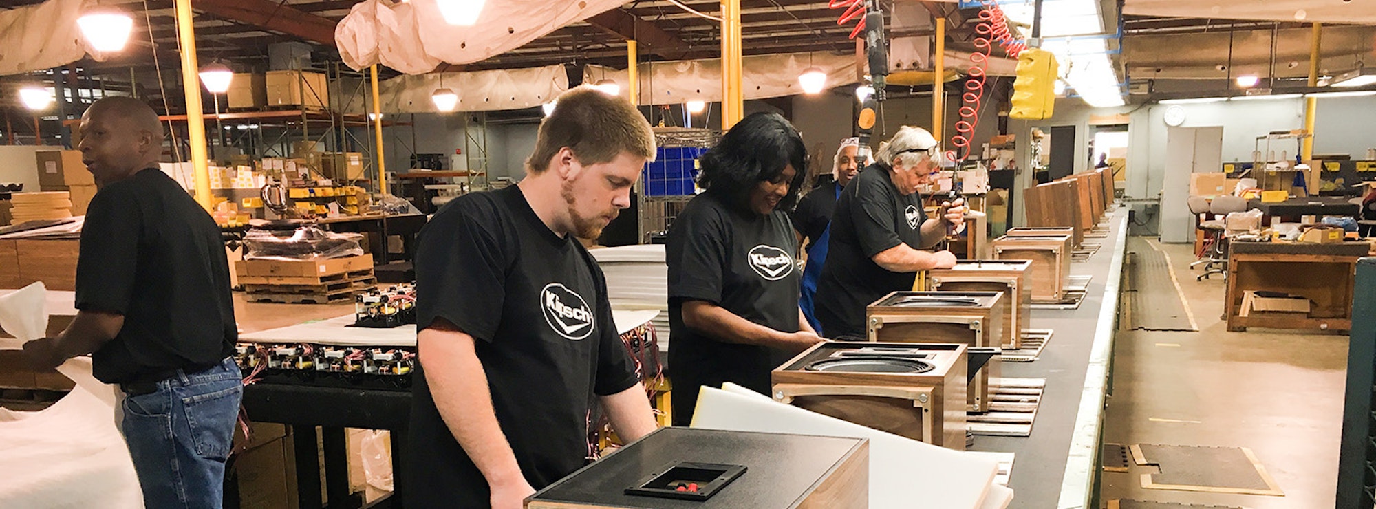Klipsch employees building speakers on an assembly line