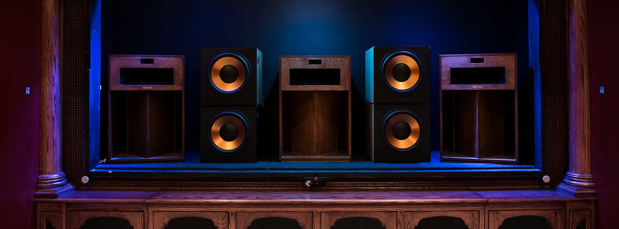 3 La Scala speakers and 4 RSW-15 subwoofers behind a home theater screen