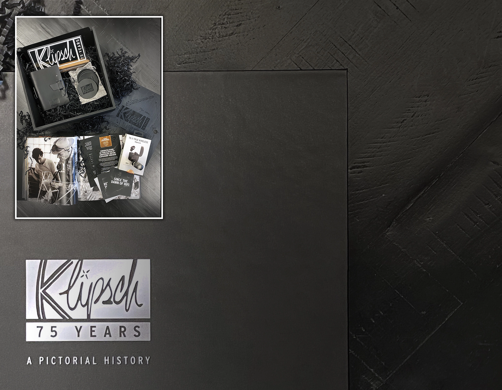 Image of additional items included with the 75th Anniversary Edition Klipsch Heritage Speakers including the 75 Years Pictorial History book a pair of T5 II True Wireless headphones and more