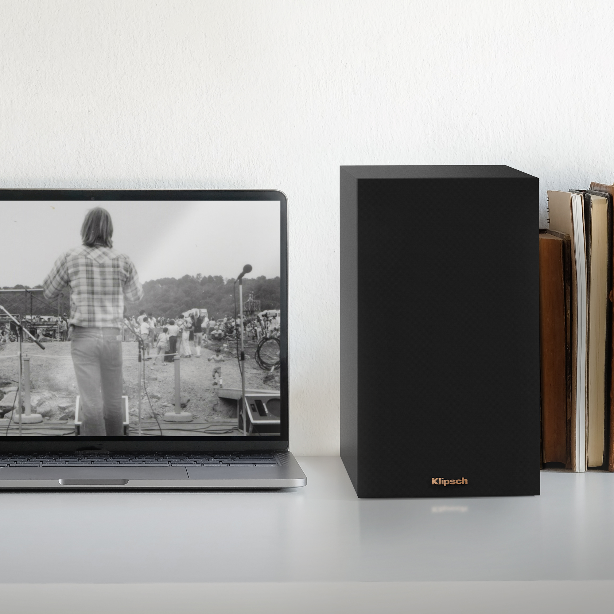 KD 400 on a desk next to a laptop computer and some books mobile