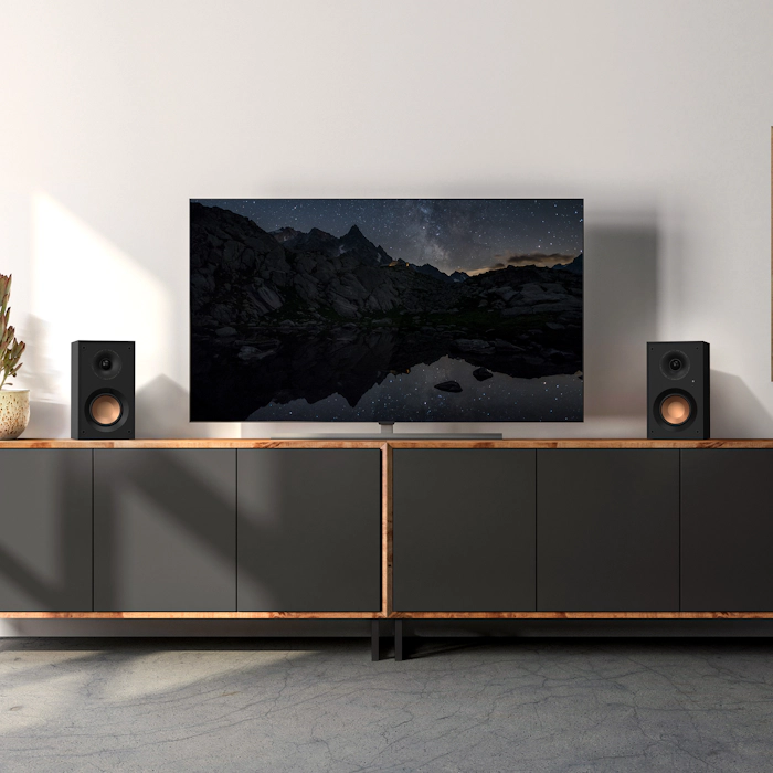 KD 400 on a grey cabinet under a TV that hangs on a wall mobile