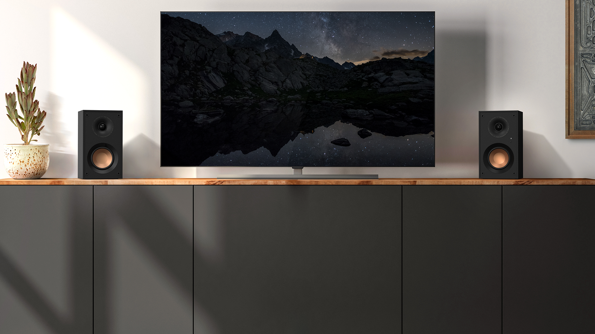 KD 400 on a grey cabinet under a TV that hangs on a wall