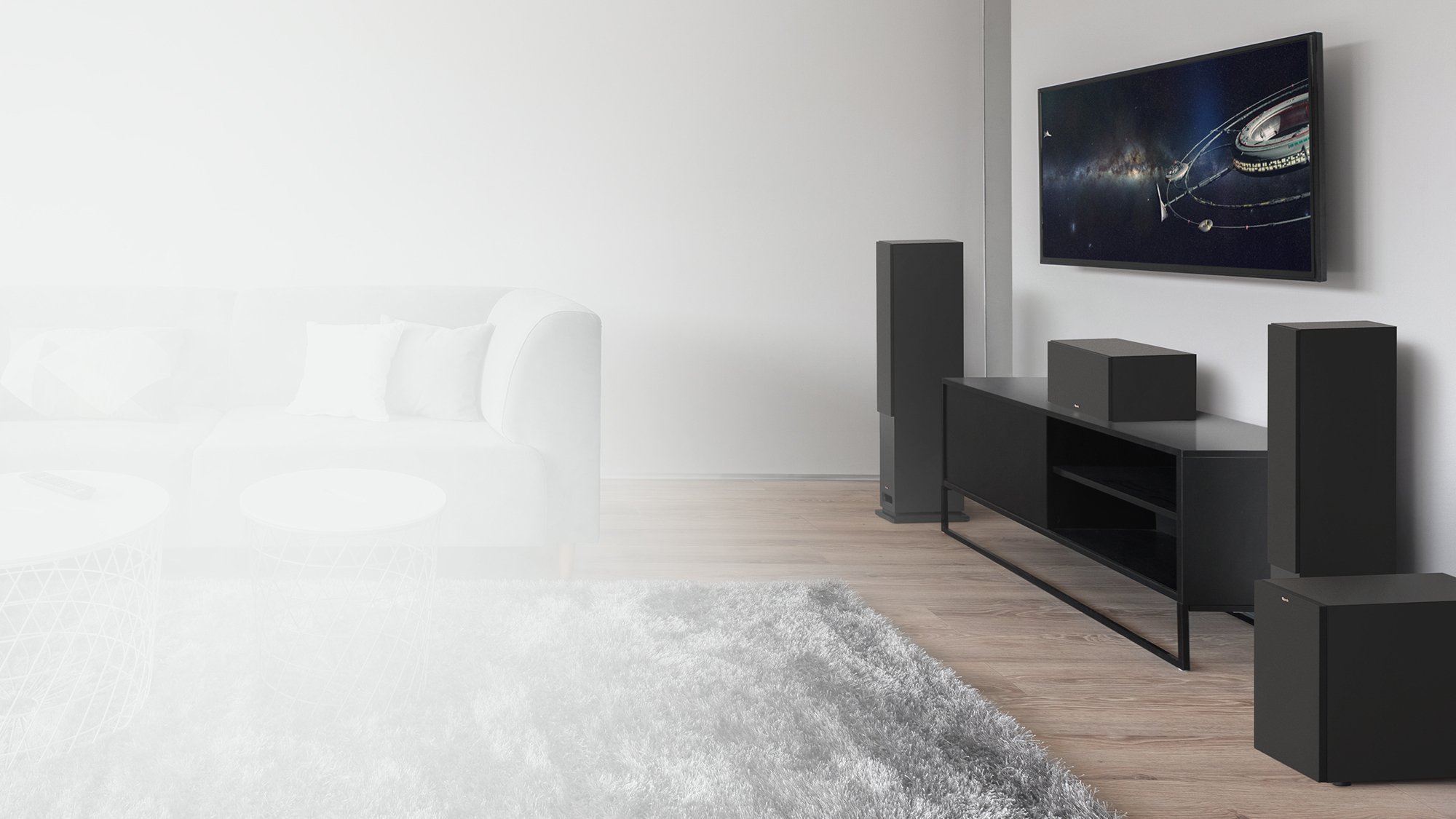 KD Series tower system with grilles on and a black credenza in a living room setting