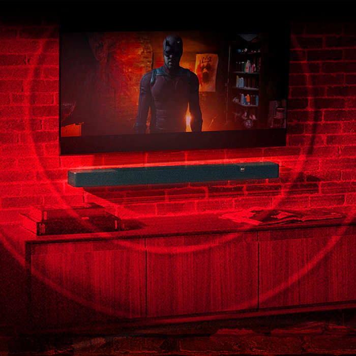 Klipsch Daredevil Partnership Flexus Core in industrial living room with red brick wall with circles emanating 2000x2000