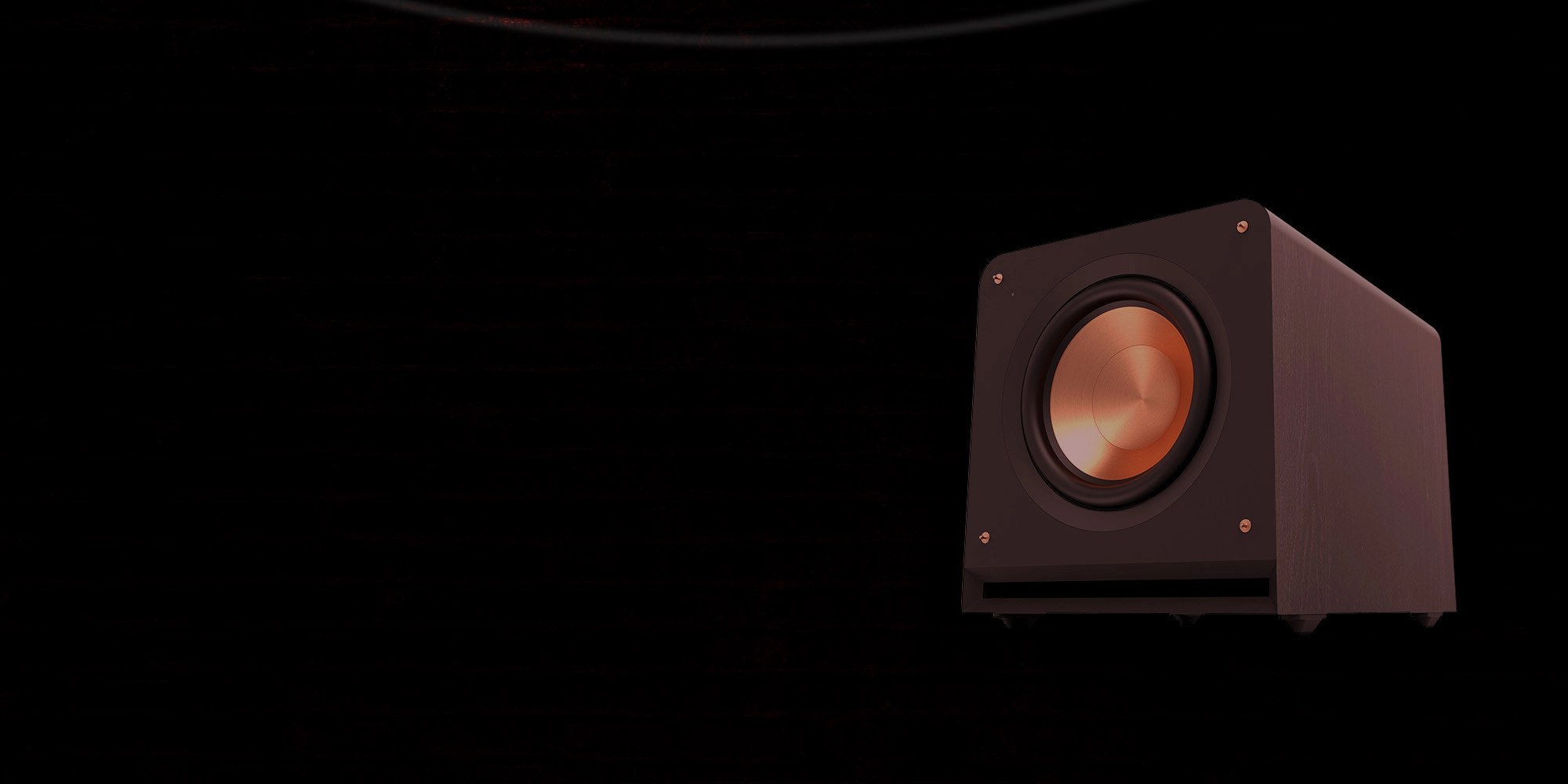 Klipsch Daredevil Partnership Klipsch Reference Premiere Subwoofer against dark red brick wall with circles emanating 2000x1000