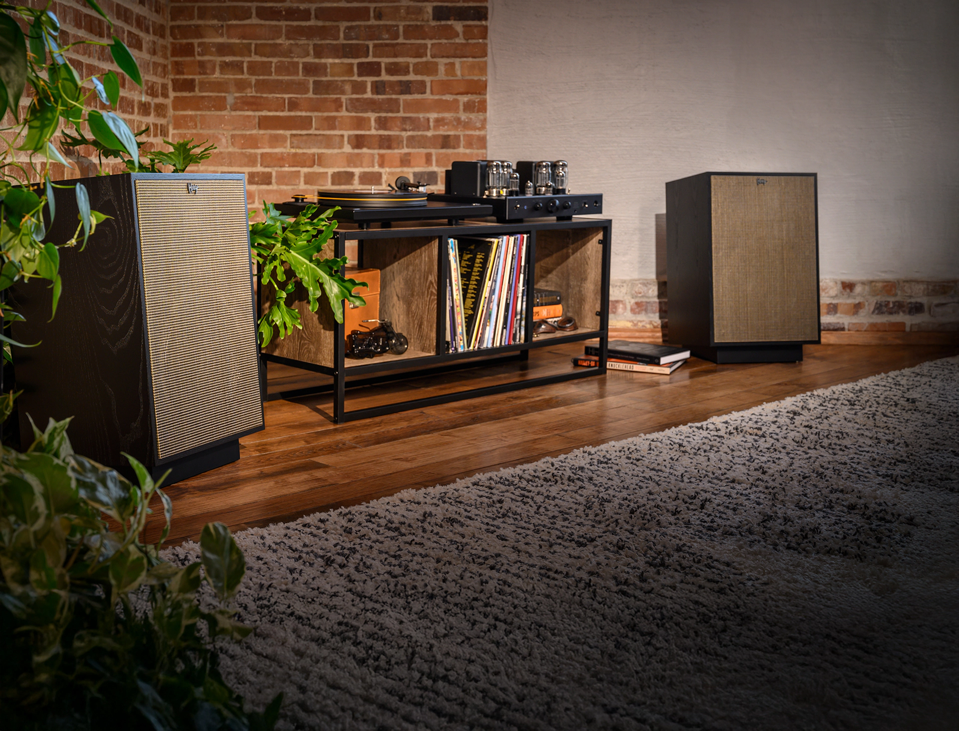 Klipsch Heresy pair in black ash flanking a record player on media console 2000x1525