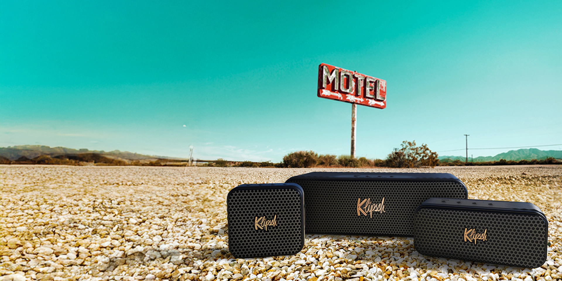 Klipsch Music City Series on road with motel in the background and bright blue sky v02 2000x1000