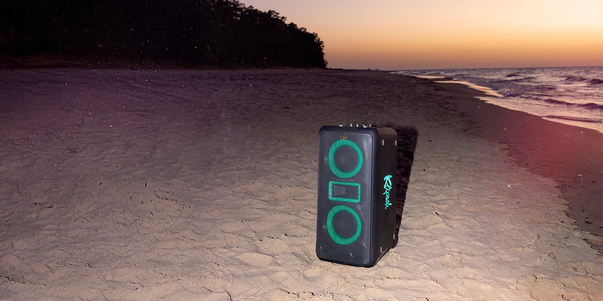 Klipsch Party Speakers Vibe speaker on the beach at sunset top 2000x1000