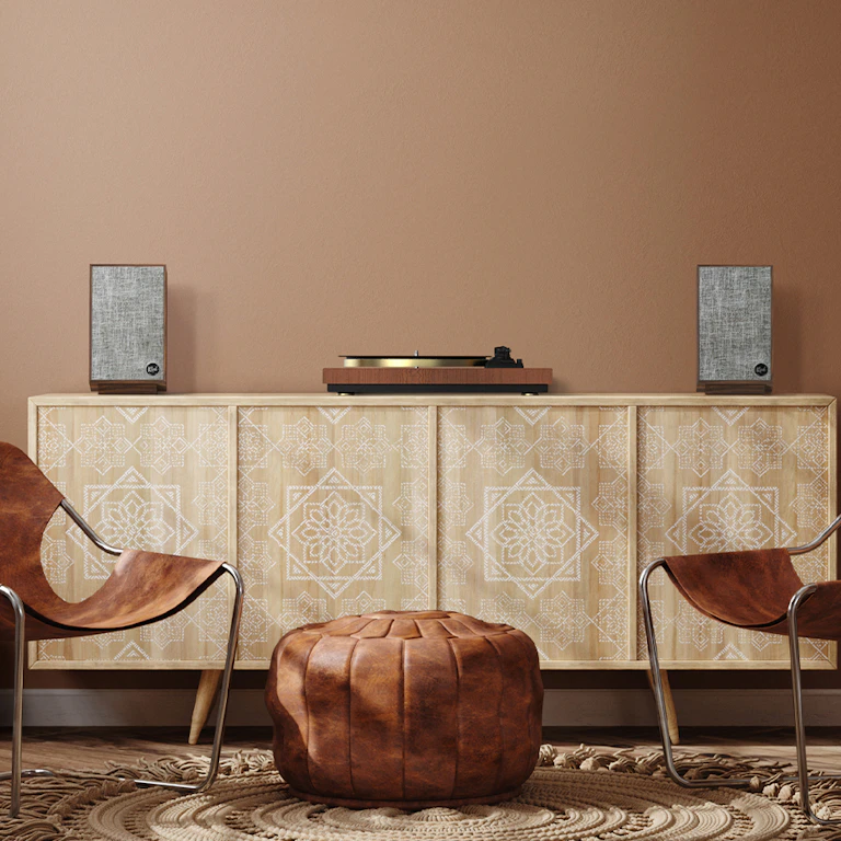 Klipsch Pro Media Heritage 2 1 speakers in a home next to a record player with 2 chairs mobile