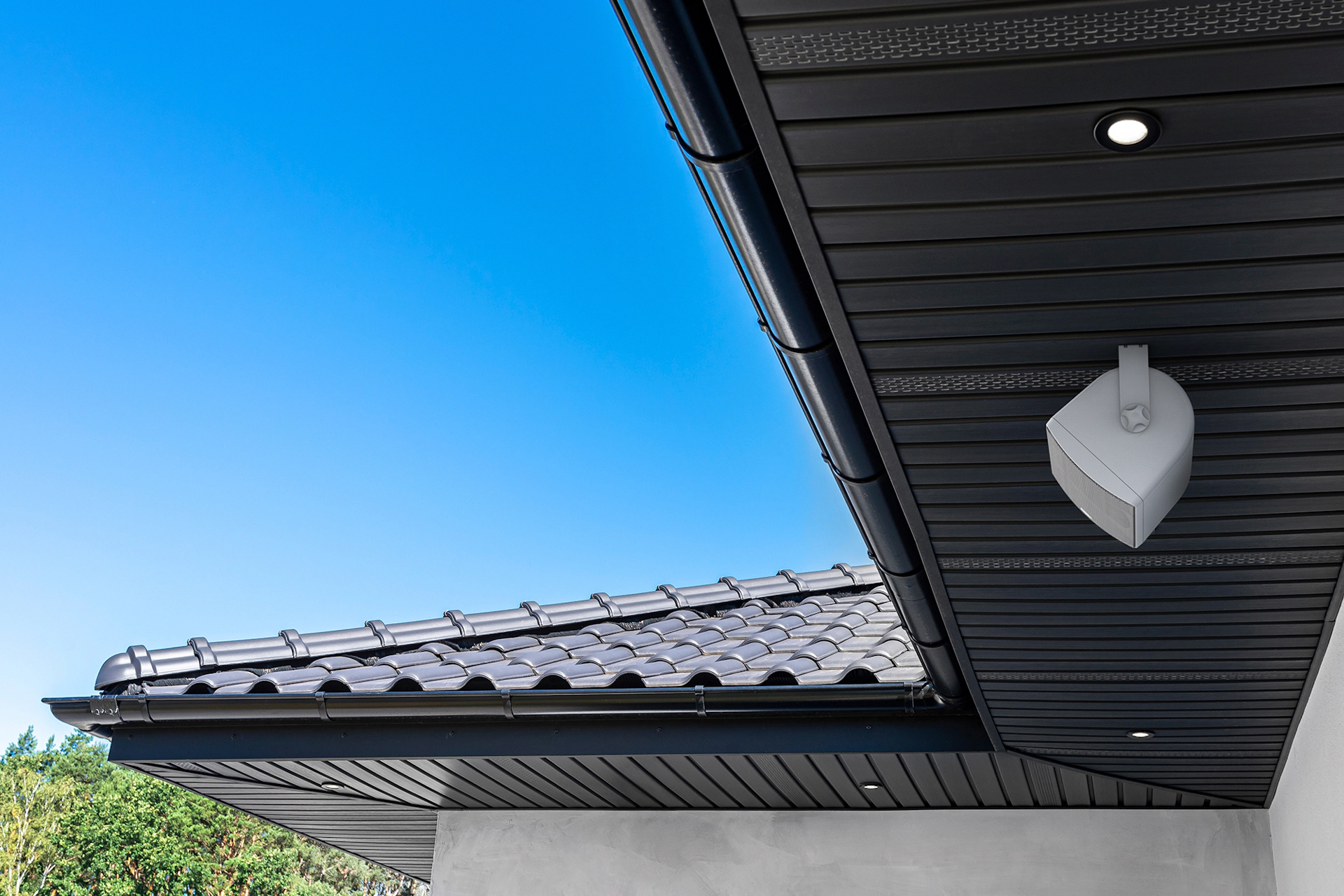 Klipsch RO 525 Outdoor Speaker Under Eaves with Sunny Skies 2000x1333