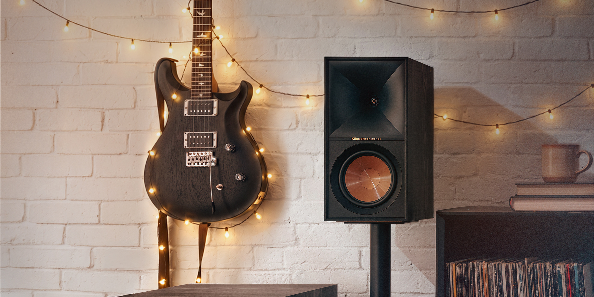 Klipsch Reference Holiday Close Up Beside Guitar 2000x1000