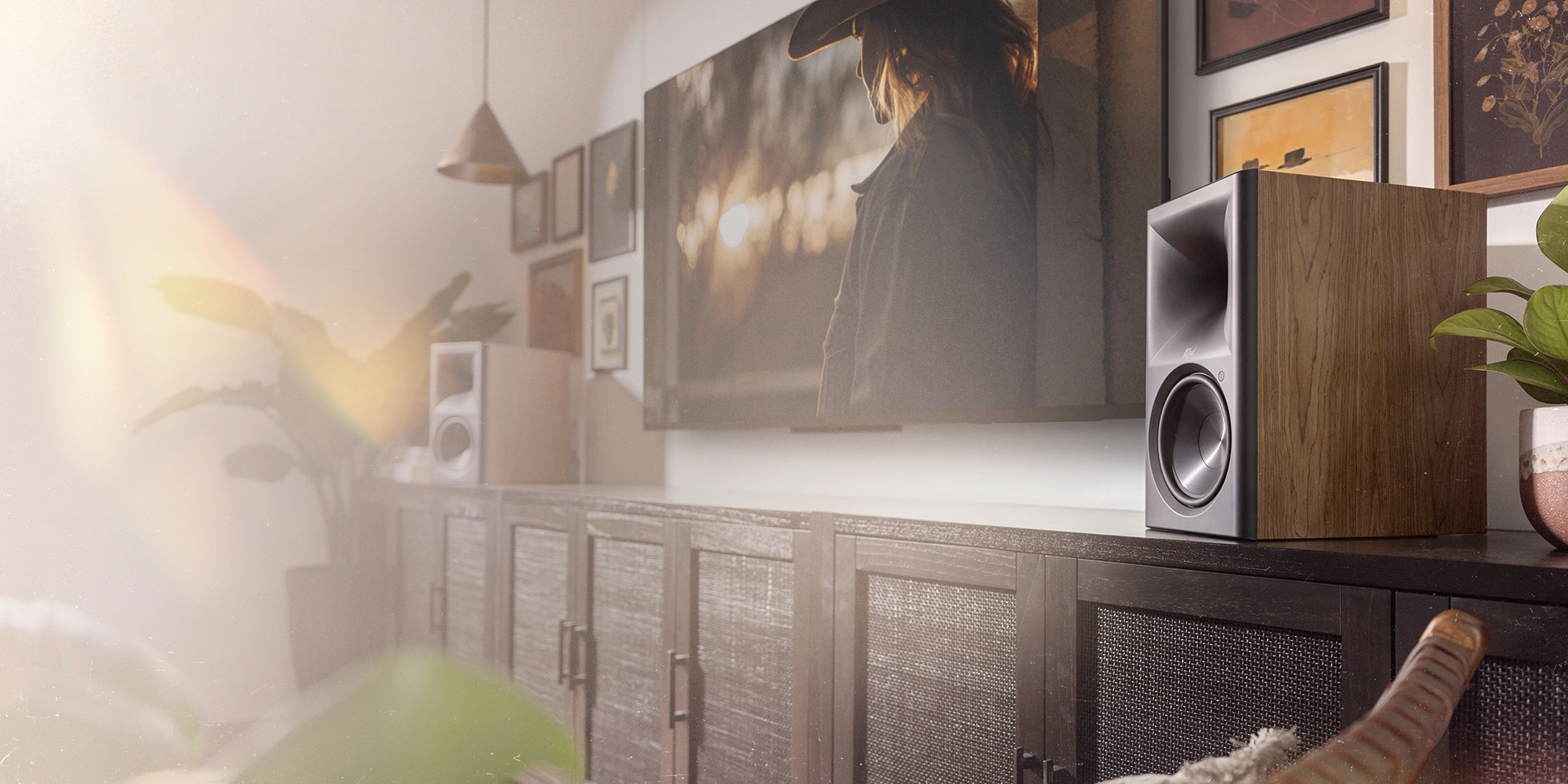 Klipsch The Sevens II Walnut on long media cabinet in front of stylish gallery wall with tv in the center7