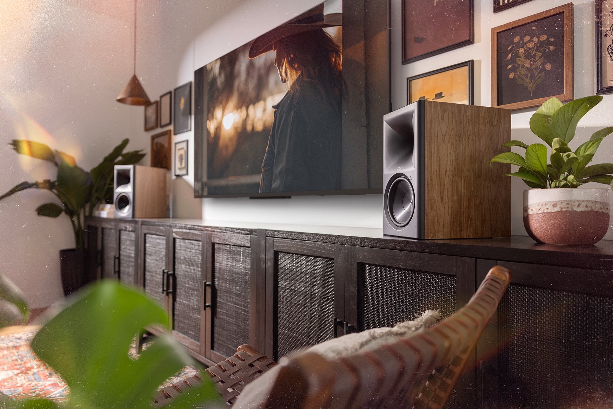 Klipsch The Sevens II Walnut on long media cabinet in front of stylish gallery wall with tv in the center 2000x1333