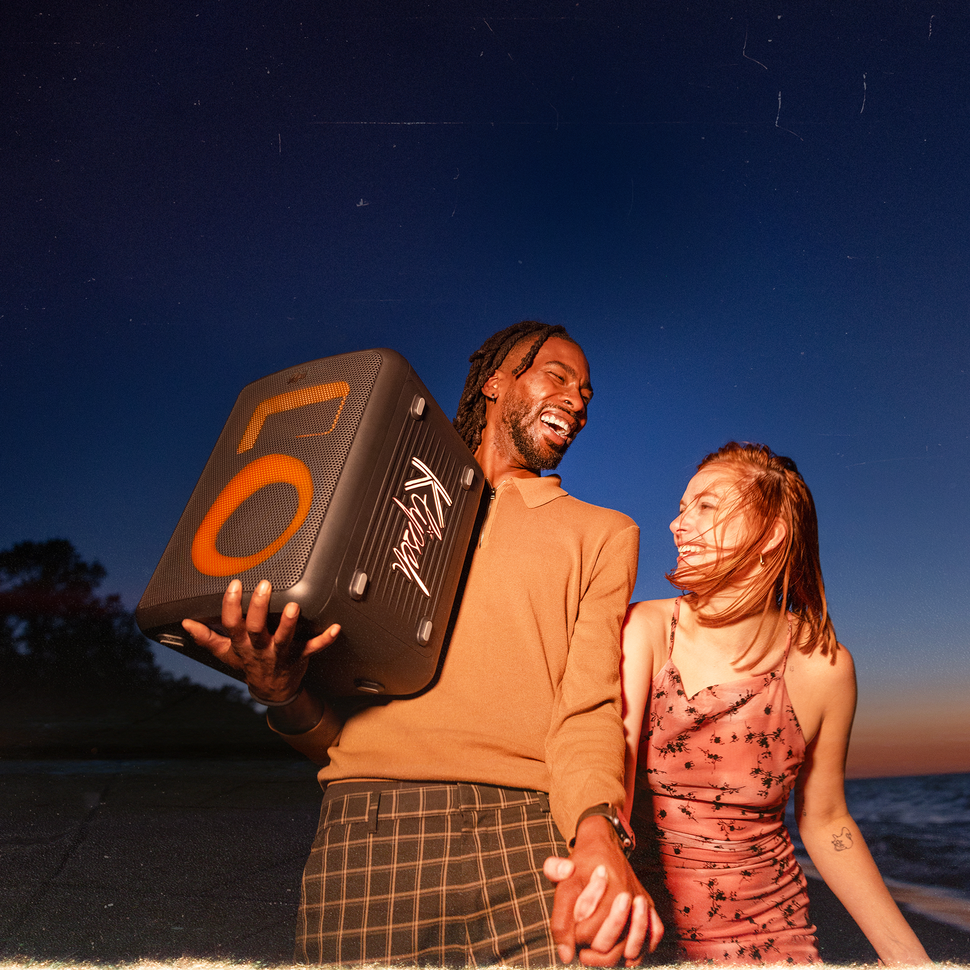 Klipsch Vegas Party Speaker with friends laughing on the beach 2000x2000