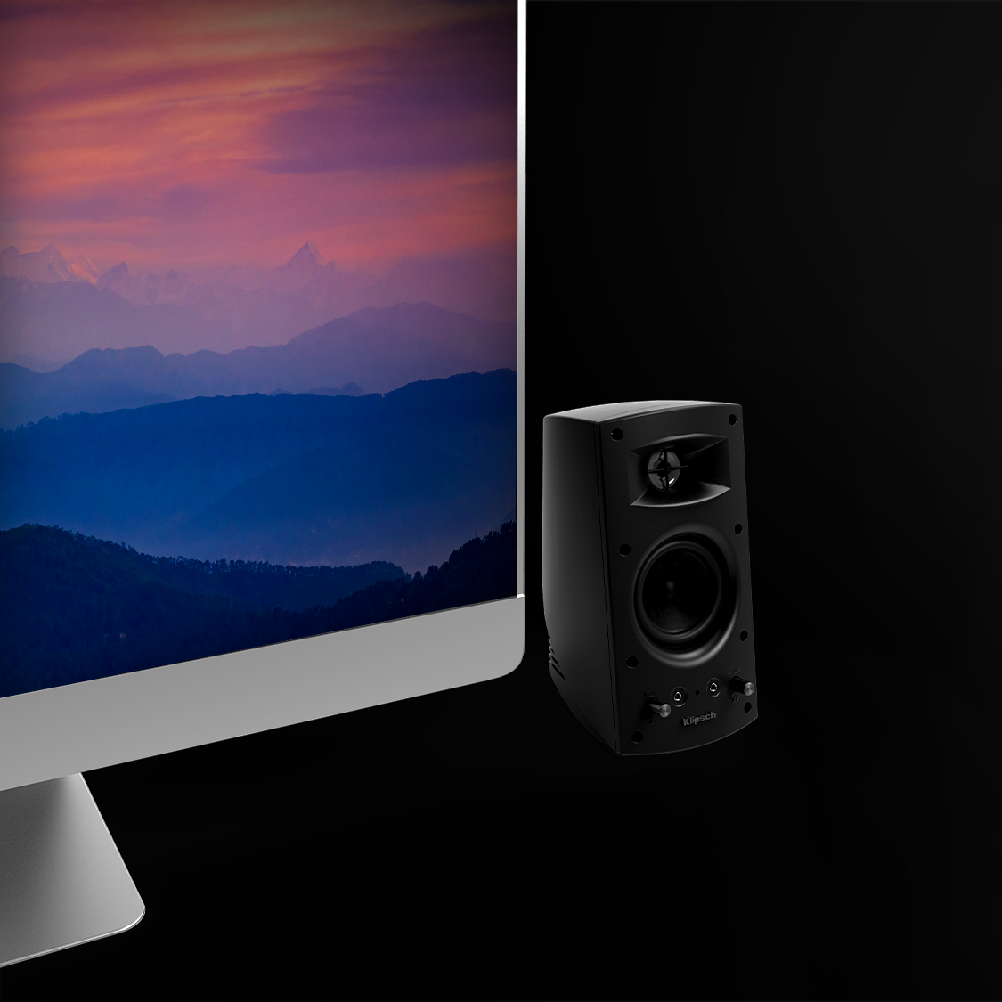 Pro Media 2 0 speaker with grille off next to a monitor mobile