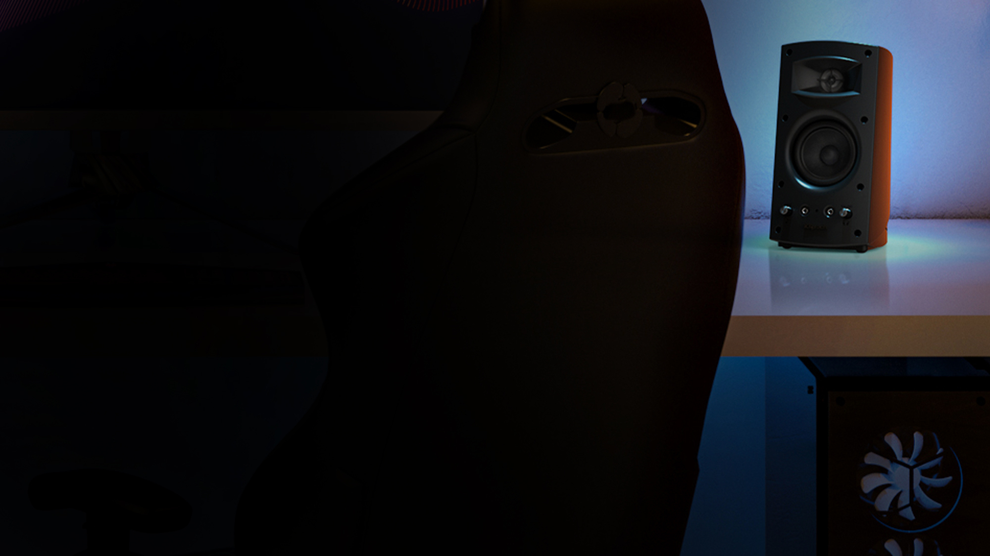 Pro Media 2 0 speaker with grille off on a computer desk