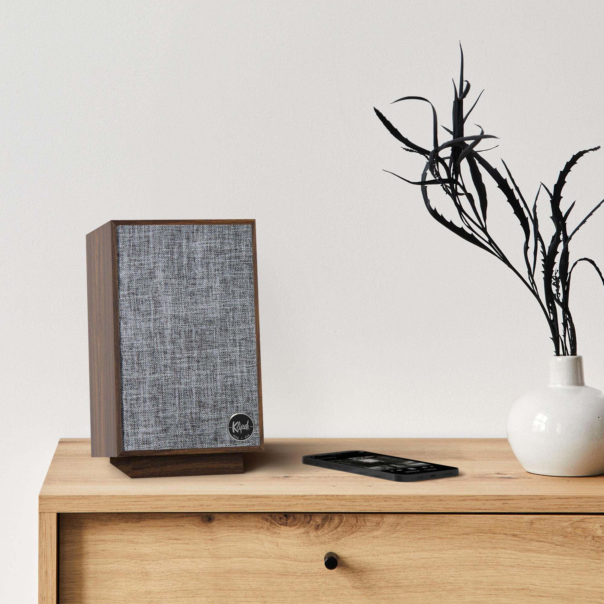 Pro Media Heritage 2 1 Speaker on a dresser next to a phone and a plant mobile