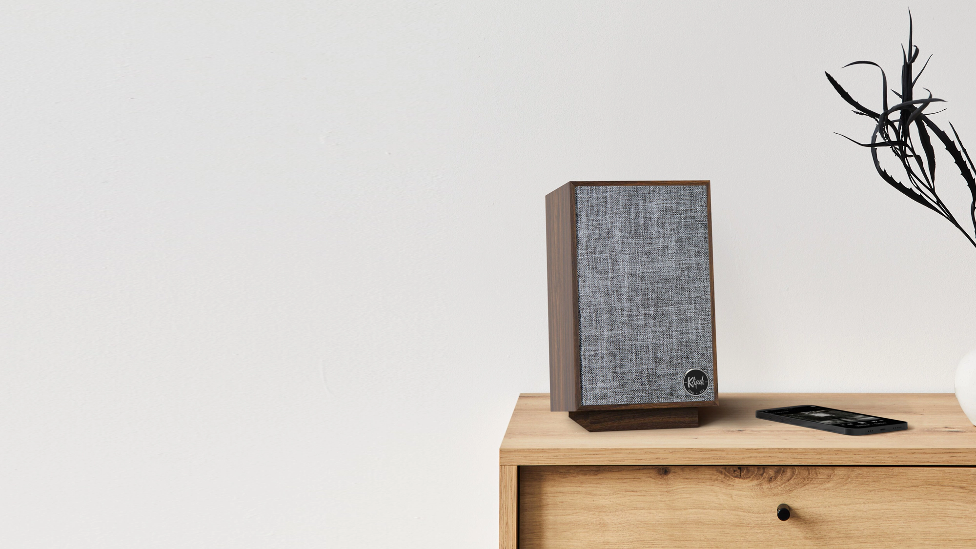 Pro Media Heritage 2 1 Speaker on a dresser next to a phone