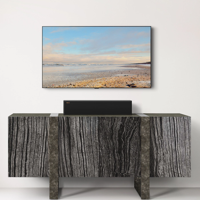 RP 404 C II Center Channel Speaker on a wooden credenza under a TV Mobile