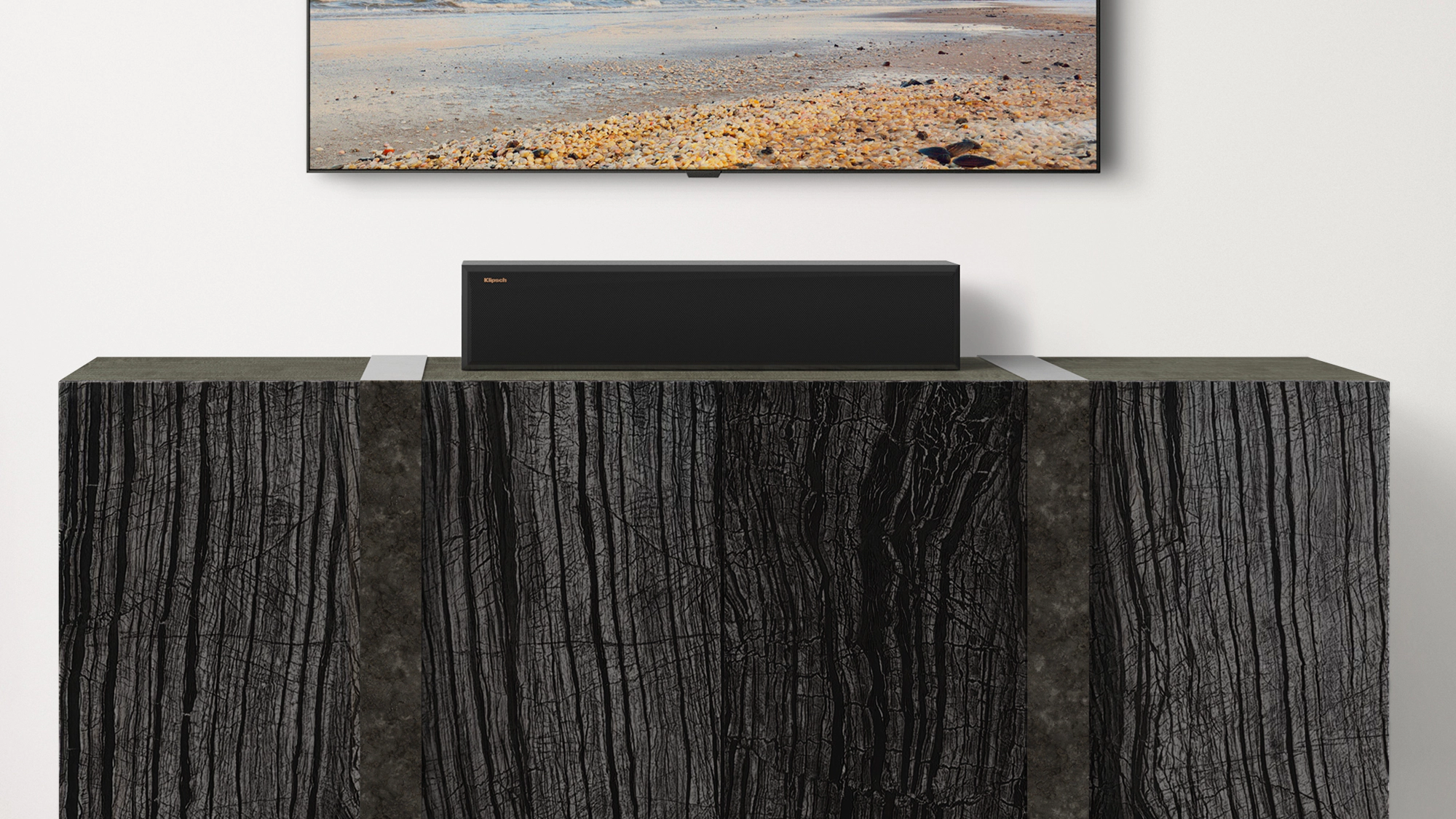 RP 404 C II Center Channel Speaker on a wooden credenza under a TV