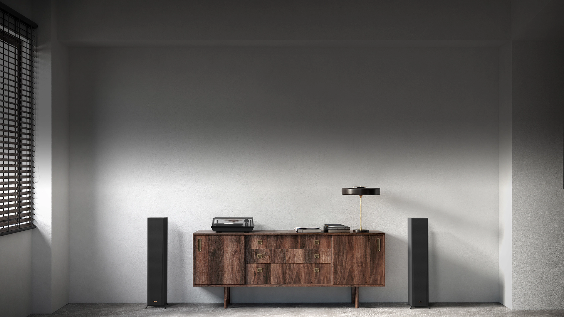 RP 5000 F speakers flanking a nice wooden credenza with a turntable lamp and books on it