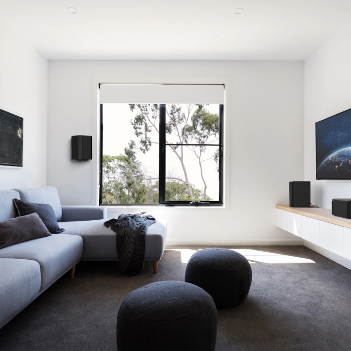 RP 502 S II surround speaker hung in a small living room home theater setting mobile