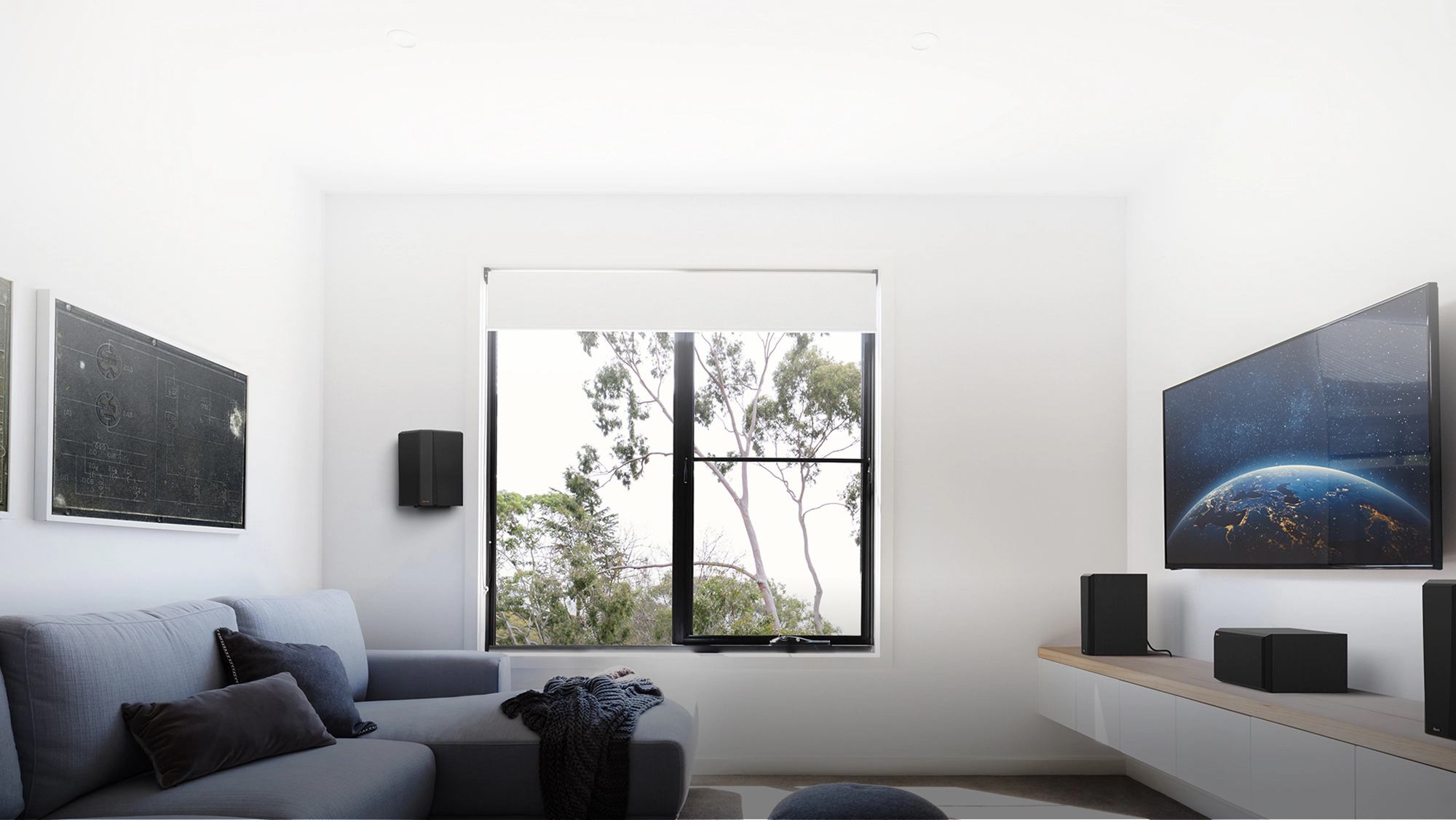 RP 502 S II surround speaker hung in a small living room home theater setting