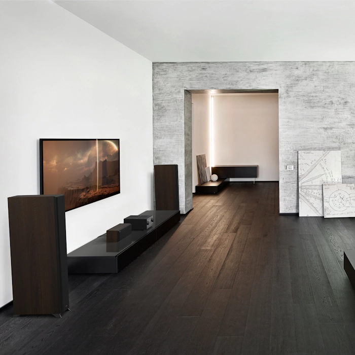 RP 6000 F speakers in a home theater setting with dark grey and black furniture mobile