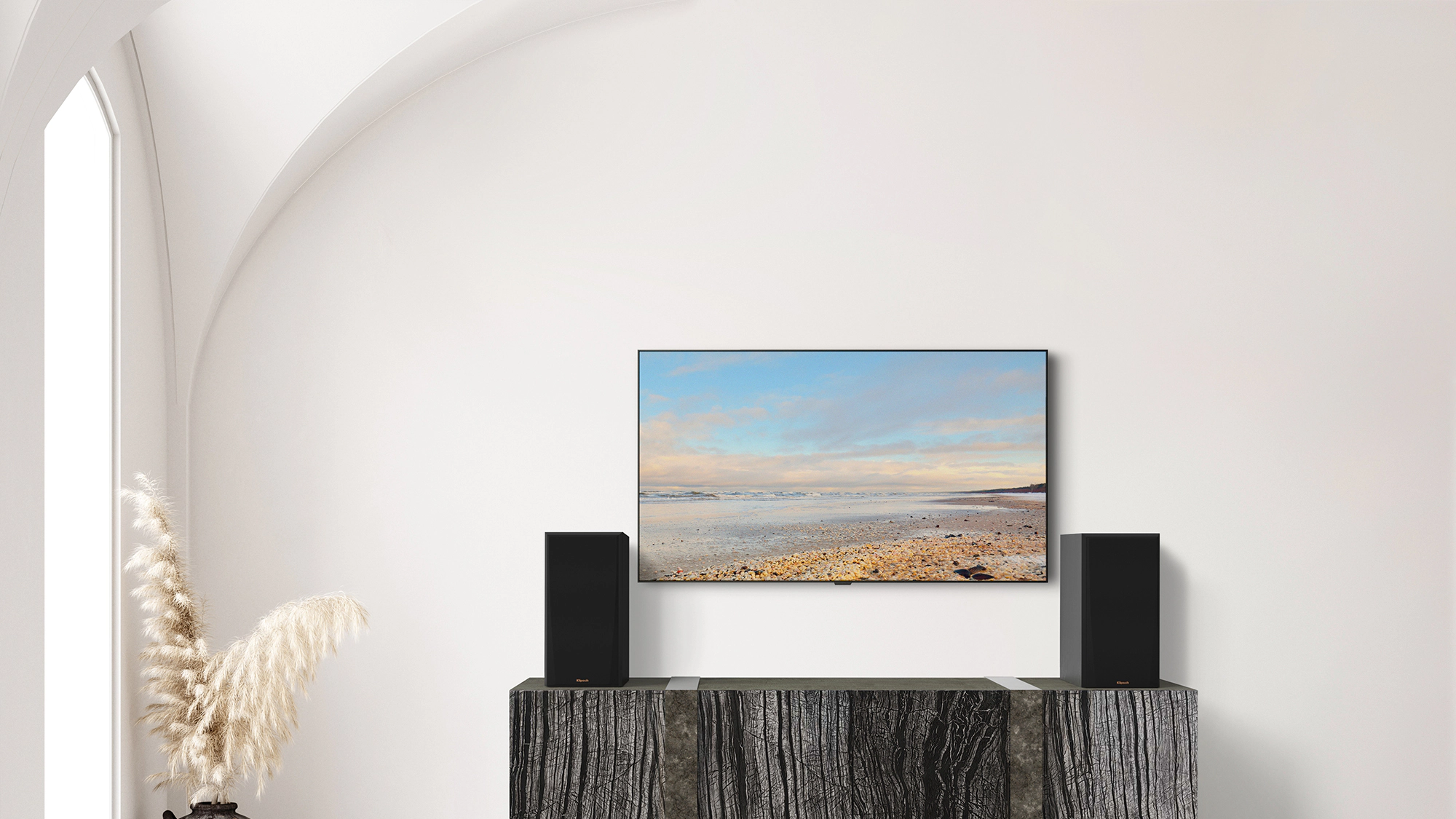 RP 600 M II on a dark grey wooden credenza under a TV