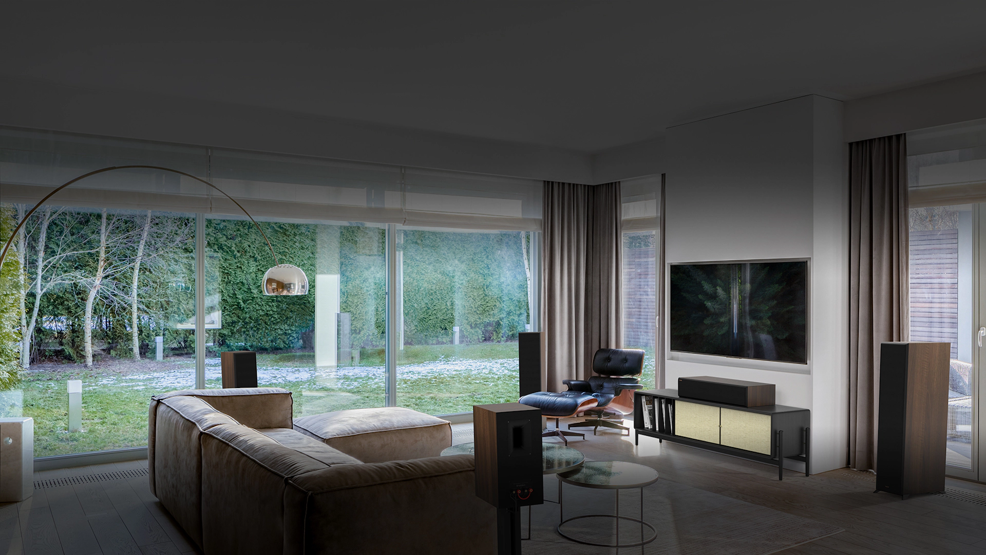 RP 8000 F II speakers in a home theater setting with brown furniture