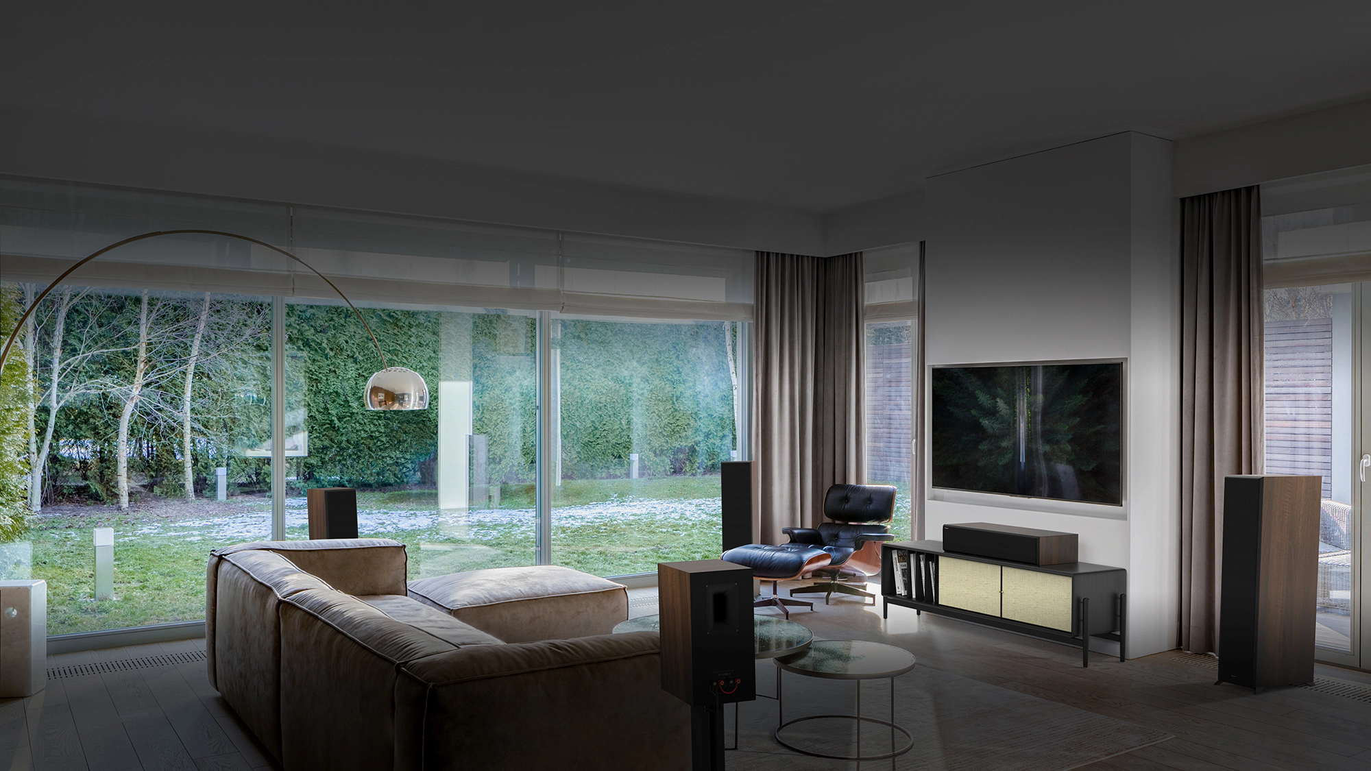 RP 8000 F II speakers in a home theater setting with brown furniture