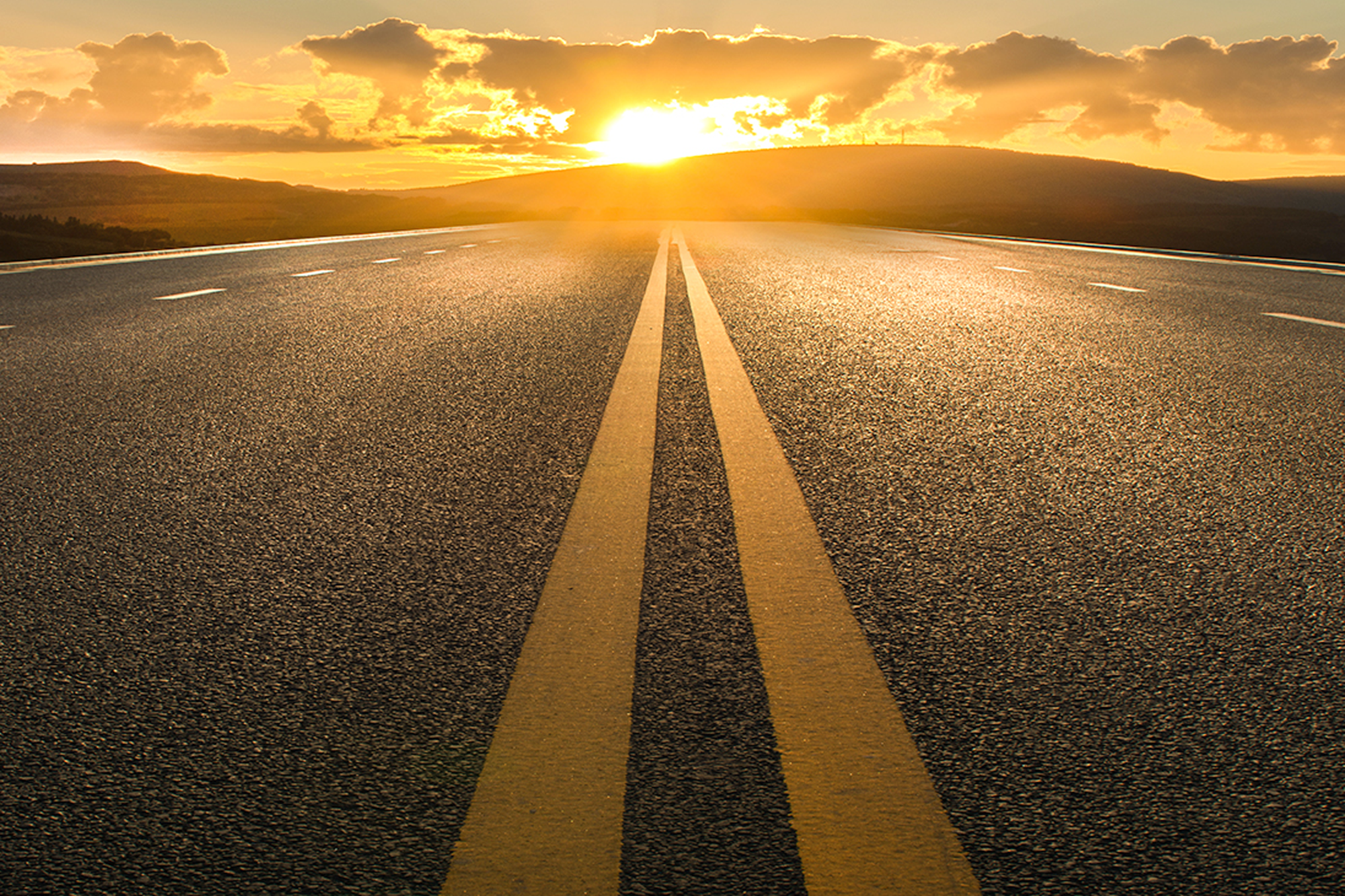 Road with sun shining at the end 2000x1333