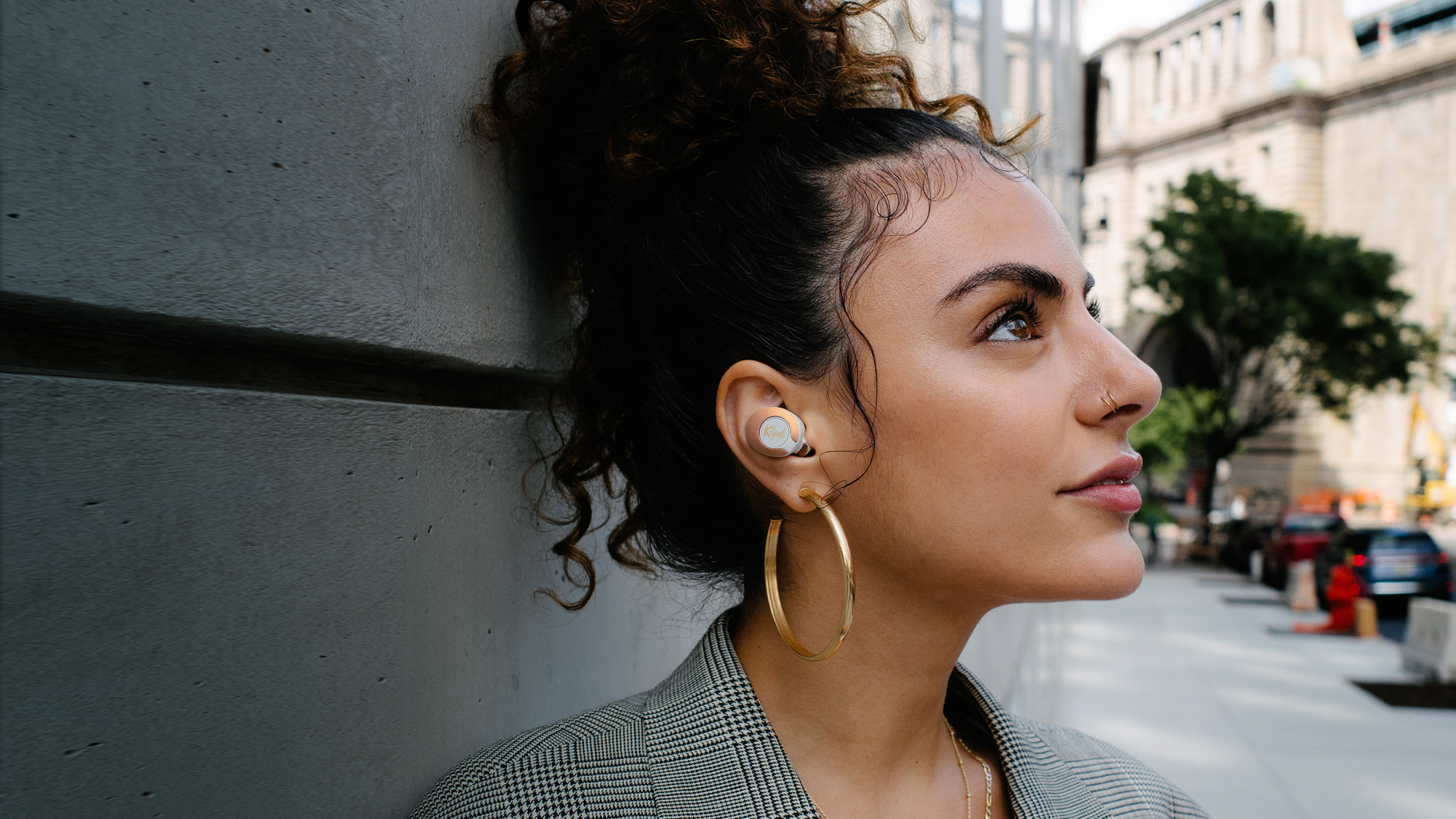 Woman looking upward while wearing Klipsch T5 II True Wireless ANC Earphones Desktop