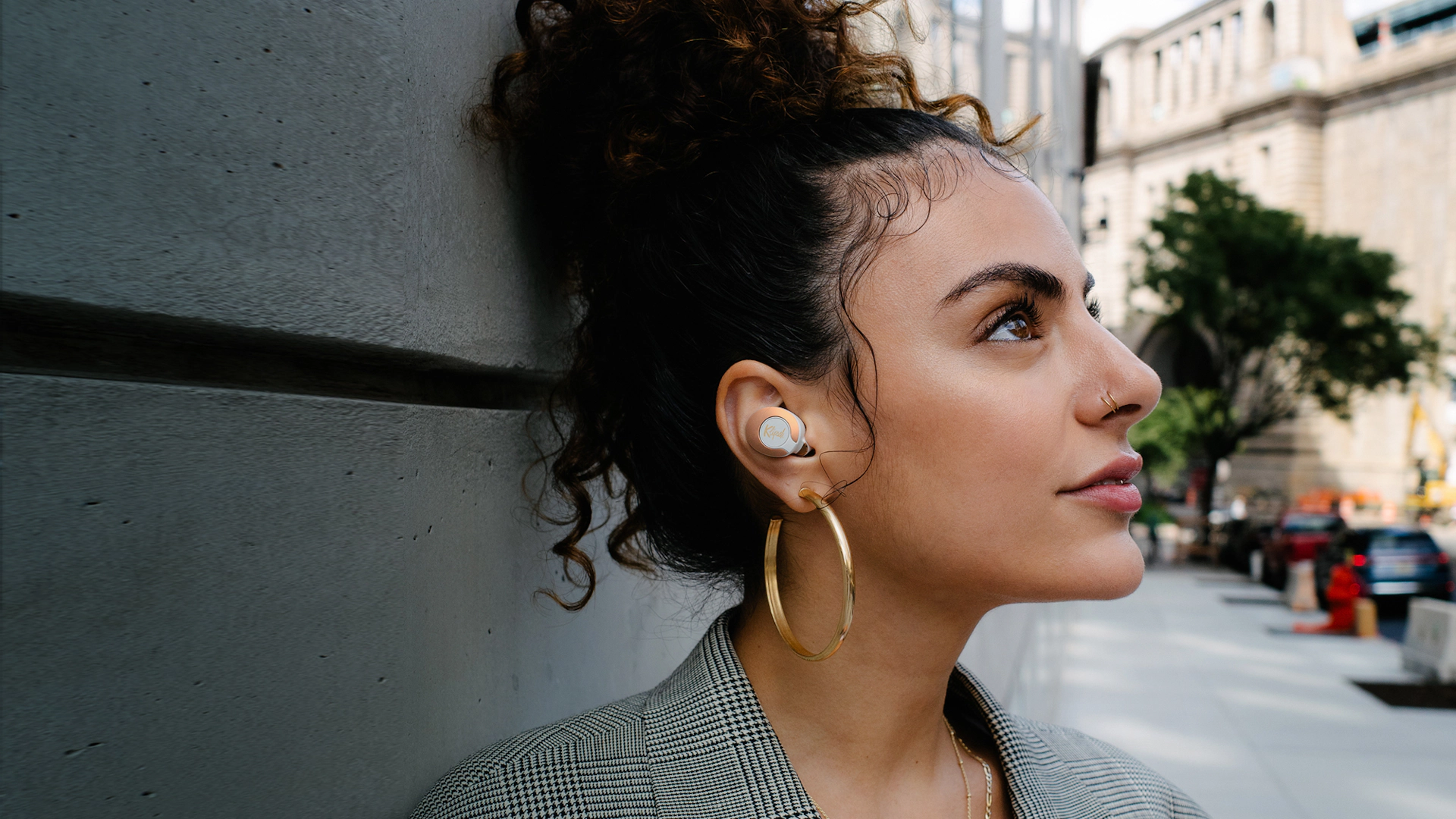 Woman looking upward while wearing Klipsch T5 II True Wireless ANC Earphones Desktop