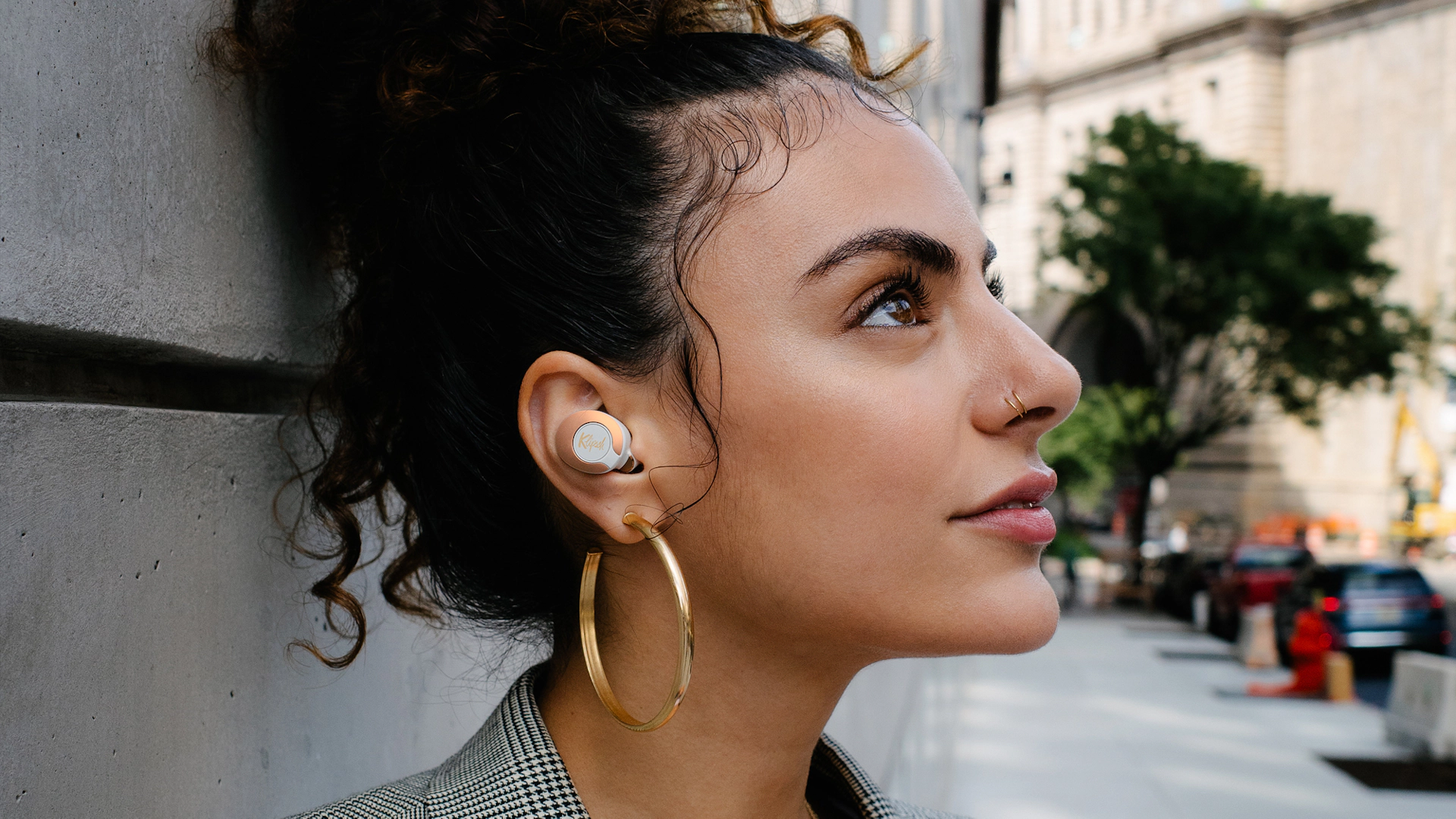 Woman looking upward while wearing Klipsch T5 II True Wireless ANC Earphones Mobile