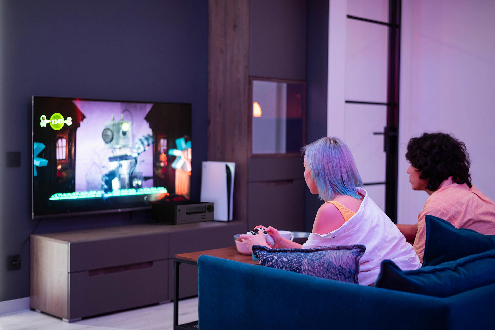 Young Adults Playing Video Games Onkyo TX NR5100 Beside TV