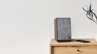 Pro Media Heritage 2 1 Speaker on a dresser next to a phone