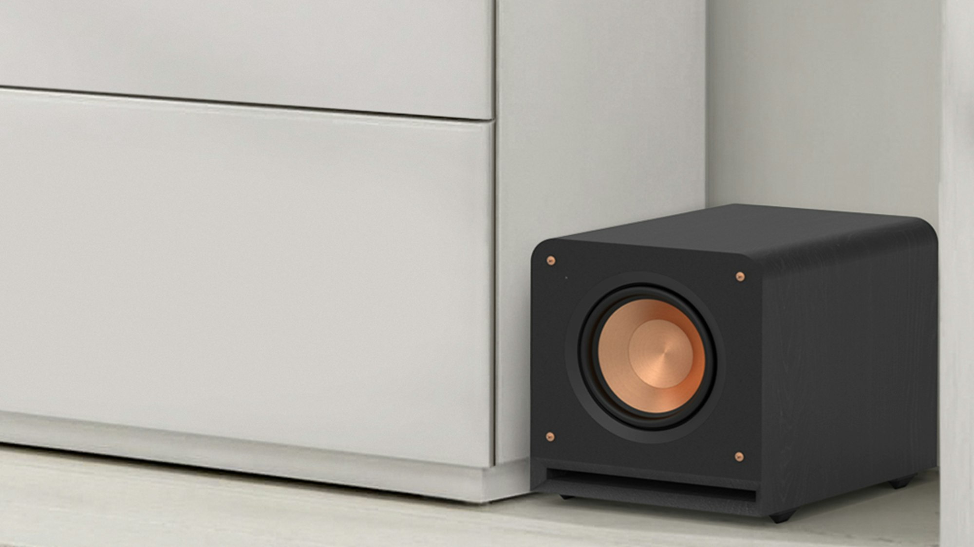 https://klipsch.imgix.net/images/RP-1000SW-subwoofer-with-grille-off-against-a-white-wall.png?auto=compress%2Cformat&fillTransforms=1&fit=clip&q=80&w=2000