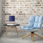 Klipsch Groove blue portable wireless speaker next to chair