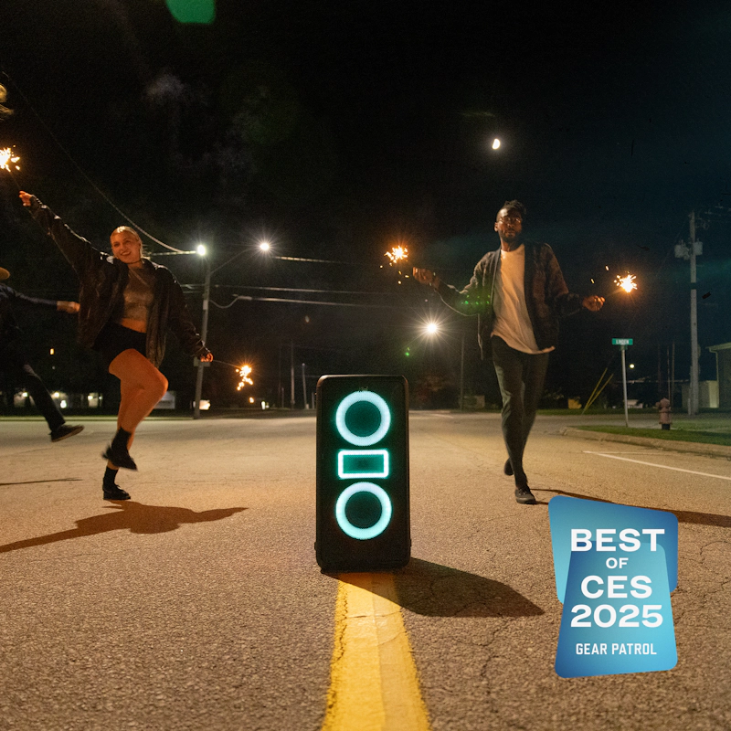 Klipsch Miami Party Speaker in middle of empty street at night with friends dancing around with sparklers with Gear Patrol Best of CES 2025 badge 2000x2000