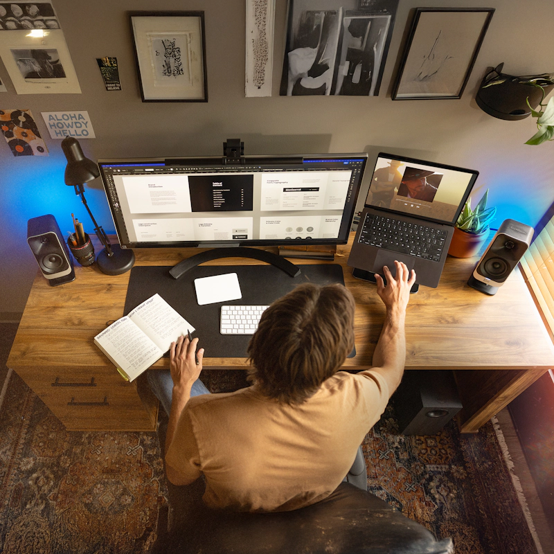 Klipsch Pro Media Lumina on Desktop Overhead with Man Working 2000x20000