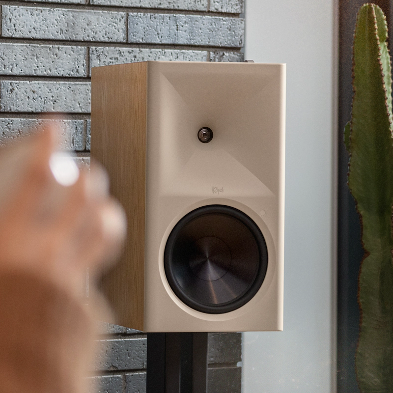 Klipsch The Nines RO on Klipsch bookshelf speaker stands beside cactus against brick feature wall 2000x2000
