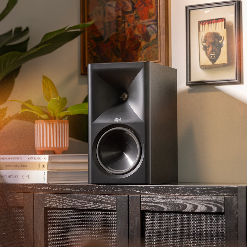 Klipsch The Sevens BK on modern media console beside plant and Americana art with warm lighting 2000x2000