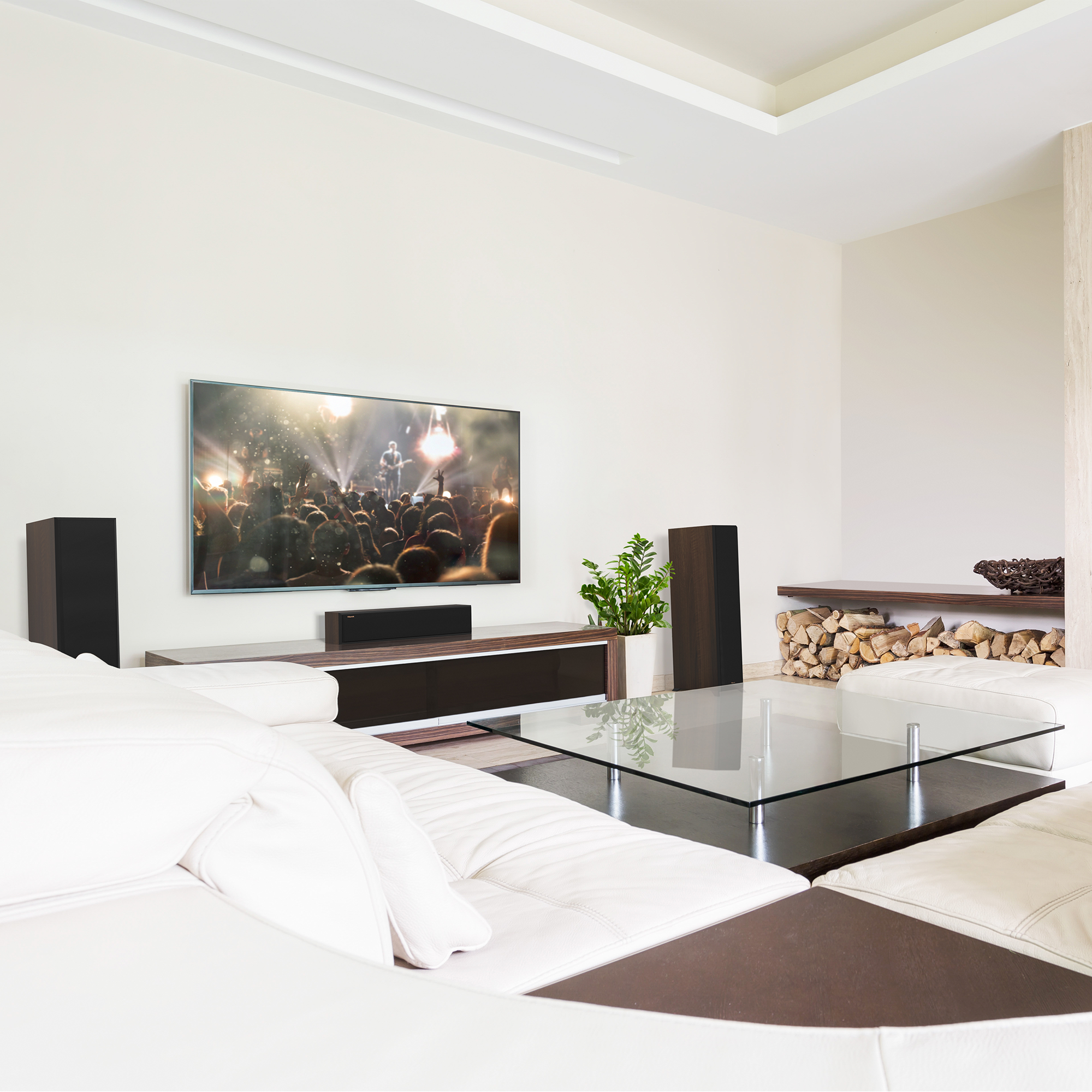 RP 404 C II sitting on a white and brown wooden credenza under a TV with its grille on in a living room setting