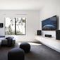 RP 404 C II sitting on a white and wooden credenza under a TV with its grille on