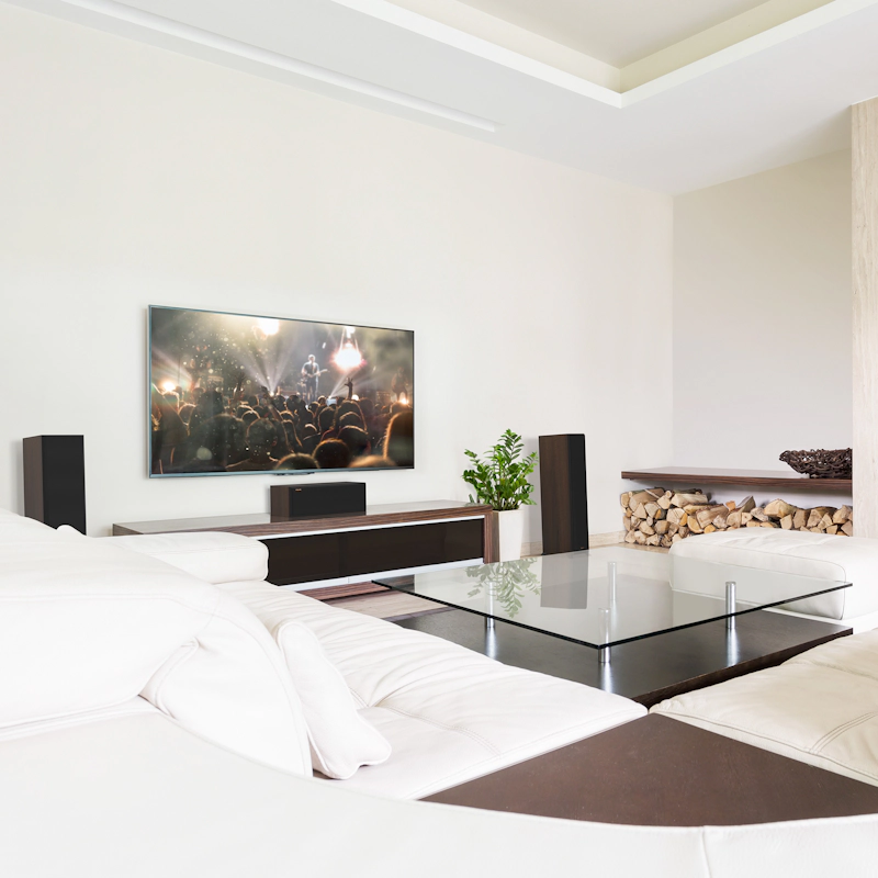 RP 500 C II sitting on a credenza under a TV with grille on in front of a large glass coffee table