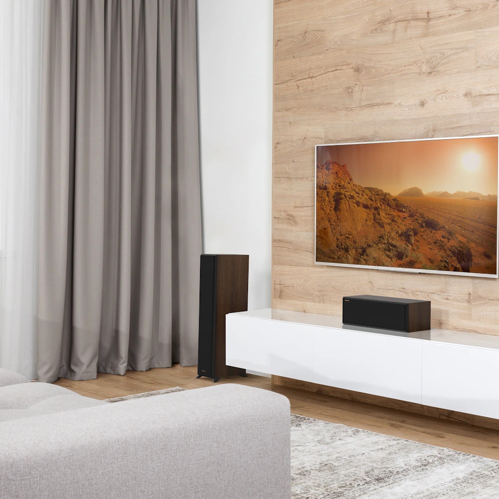RP 500 C II sitting on a grey white credenza under a TV with grille on
