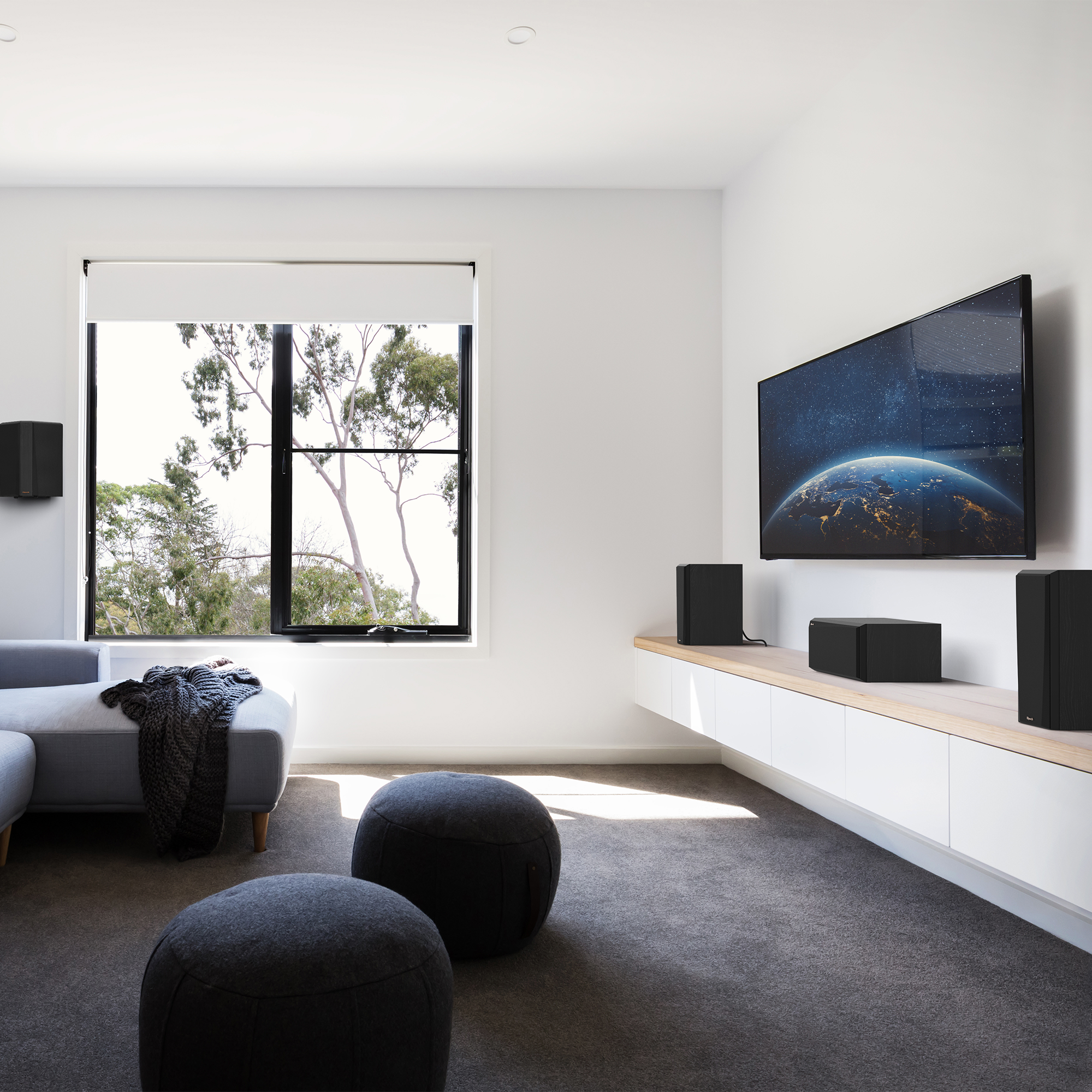 RP 500 C II sitting on a white and wood colored credenza under a TV with grille on in front of some interesting furniture
