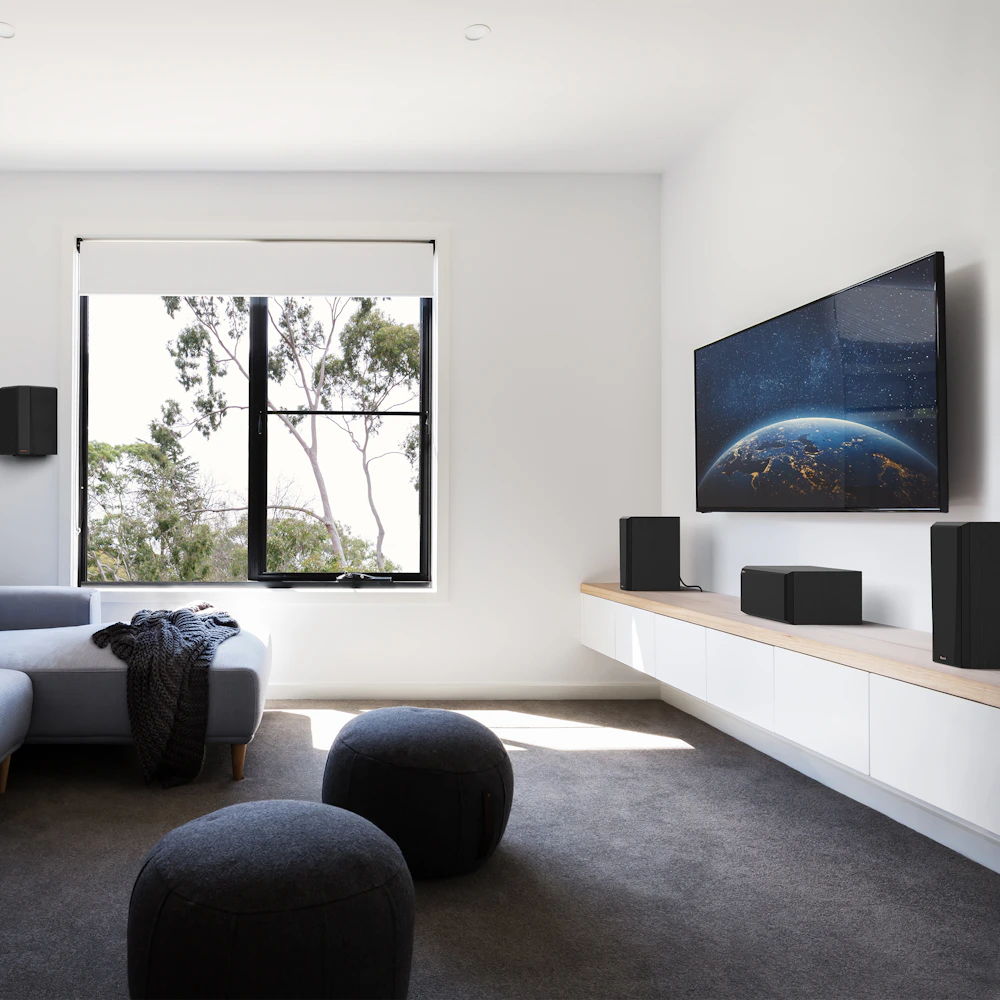 RP 500 C II sitting on a white and wood colored credenza under a TV with grille on in front of some interesting furniture