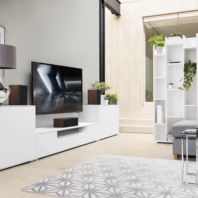 RP 500 C II sitting on a white credenza under a T Vwith grille on in front of a rug